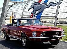 Mustang legends Carroll Shelby (L) and John Force drive into the opening ceremonies for Mustang's 40th anniversary celebration at the Nashville Superspeedway in a 1968 Shelby GT500 KR.